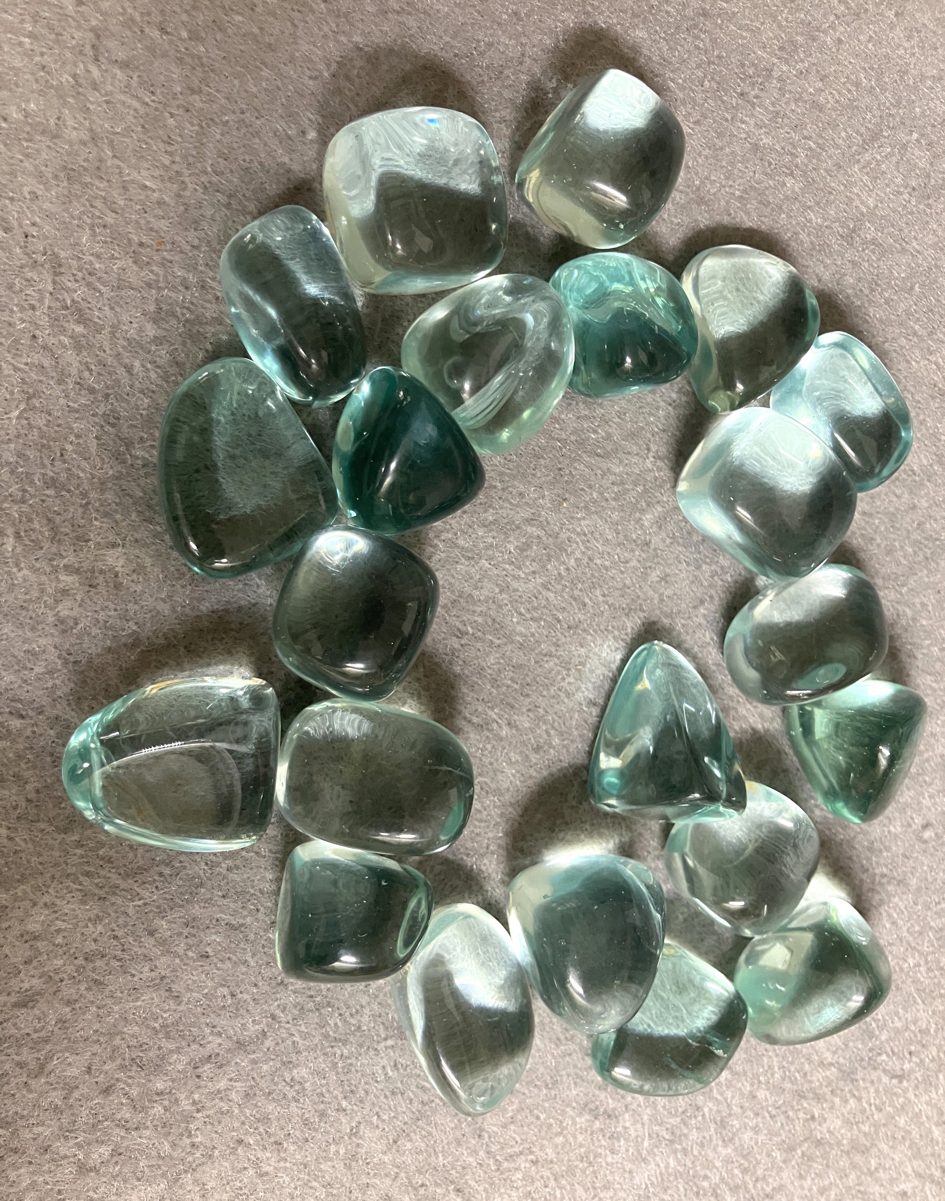 Collection of Blue Obsidian Crystal on a beige surface