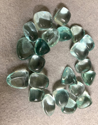 Collection of Blue Obsidian Crystal on a beige surface