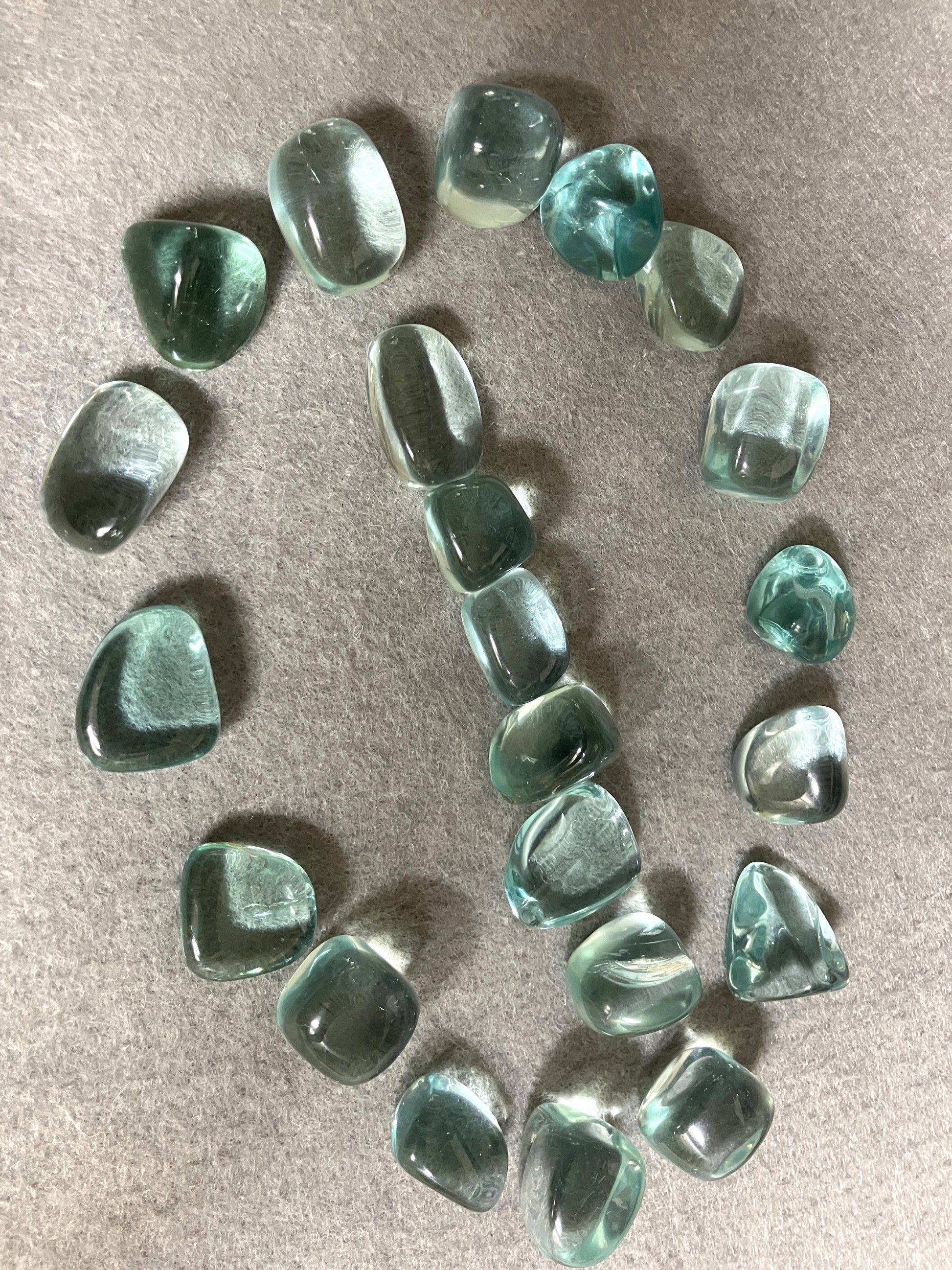 Blue Obsidian Crystal shown in a grid formation on a beige fabric background