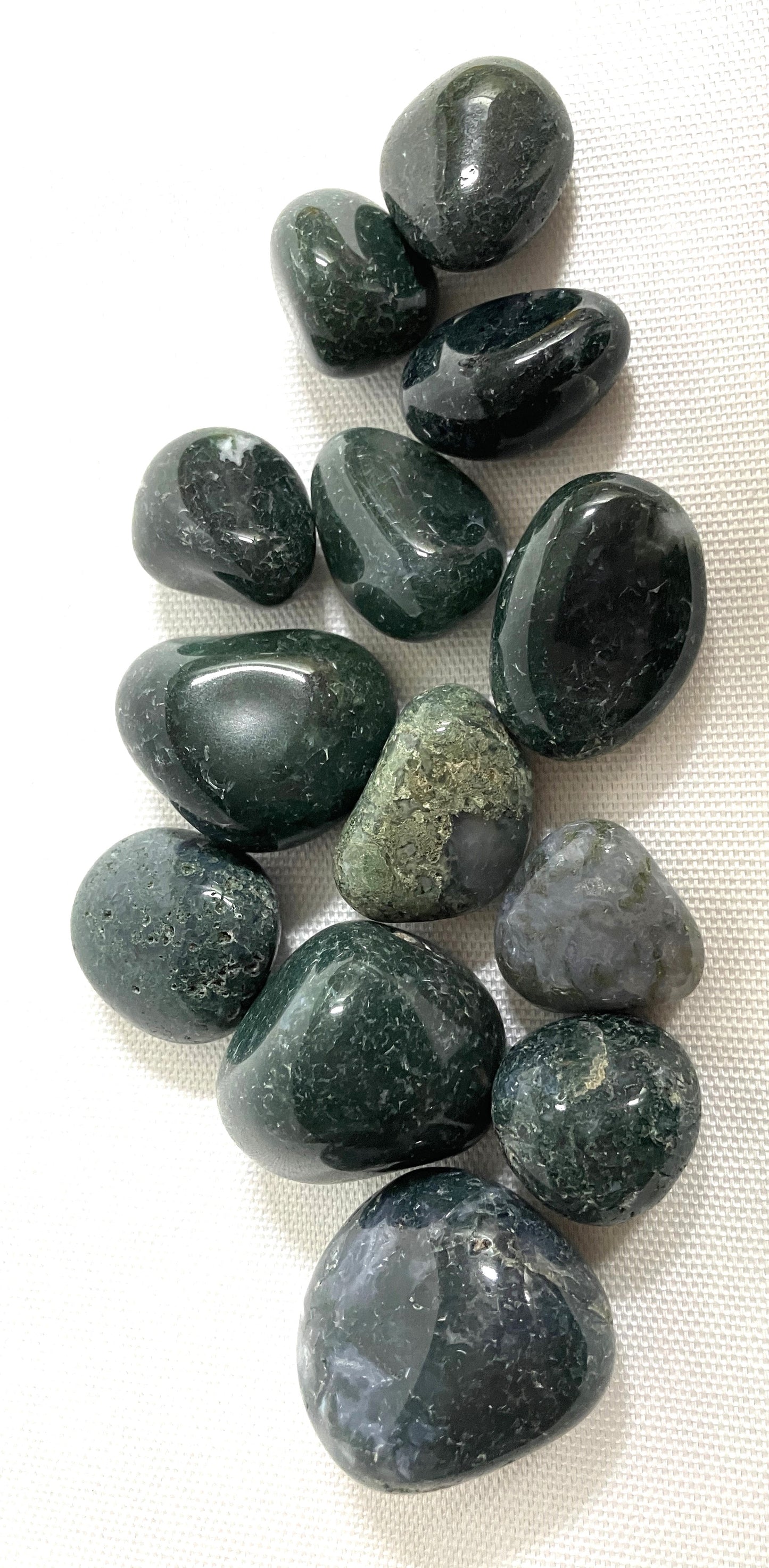 Group of Moss Agate Crystals  on a white fabric background