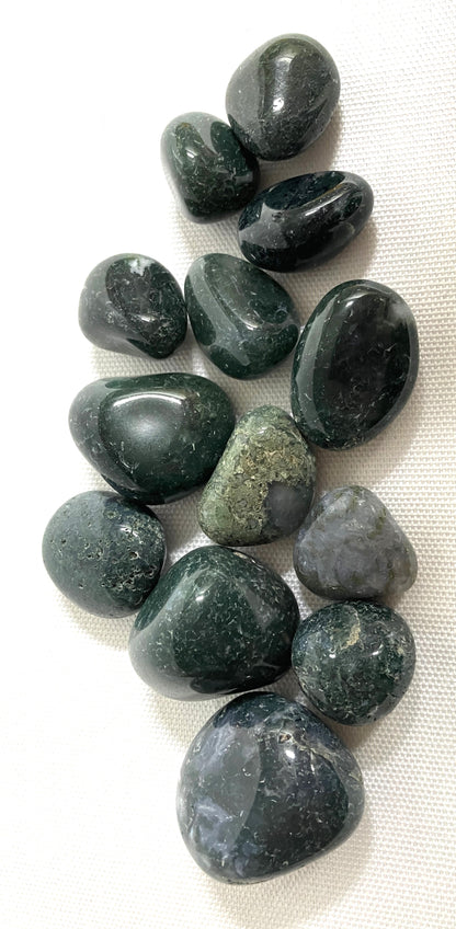 Group of Moss Agate Crystals  on a white fabric background