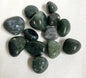 Collection of Moss Agate Crystals  showing the front on a white fabric background