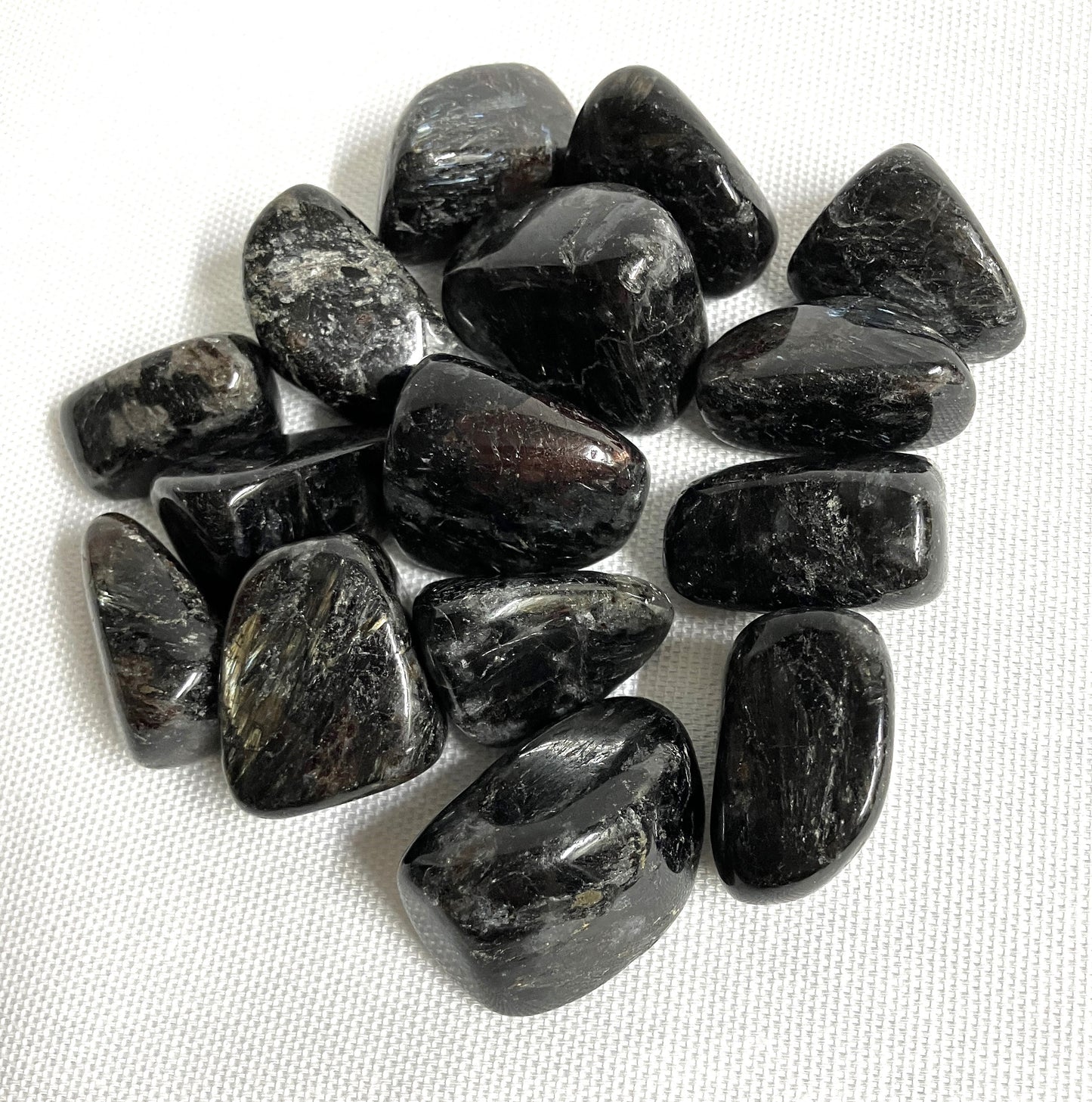 Closeup of Astrophyllite Crystals  on a white fabric background