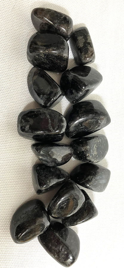 Showing Astrophyllite Crystals from the front on a white fabric background