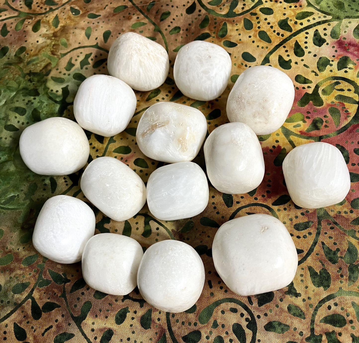 Back view of Scolecite Crystals on a decorative plate with a floral pattern