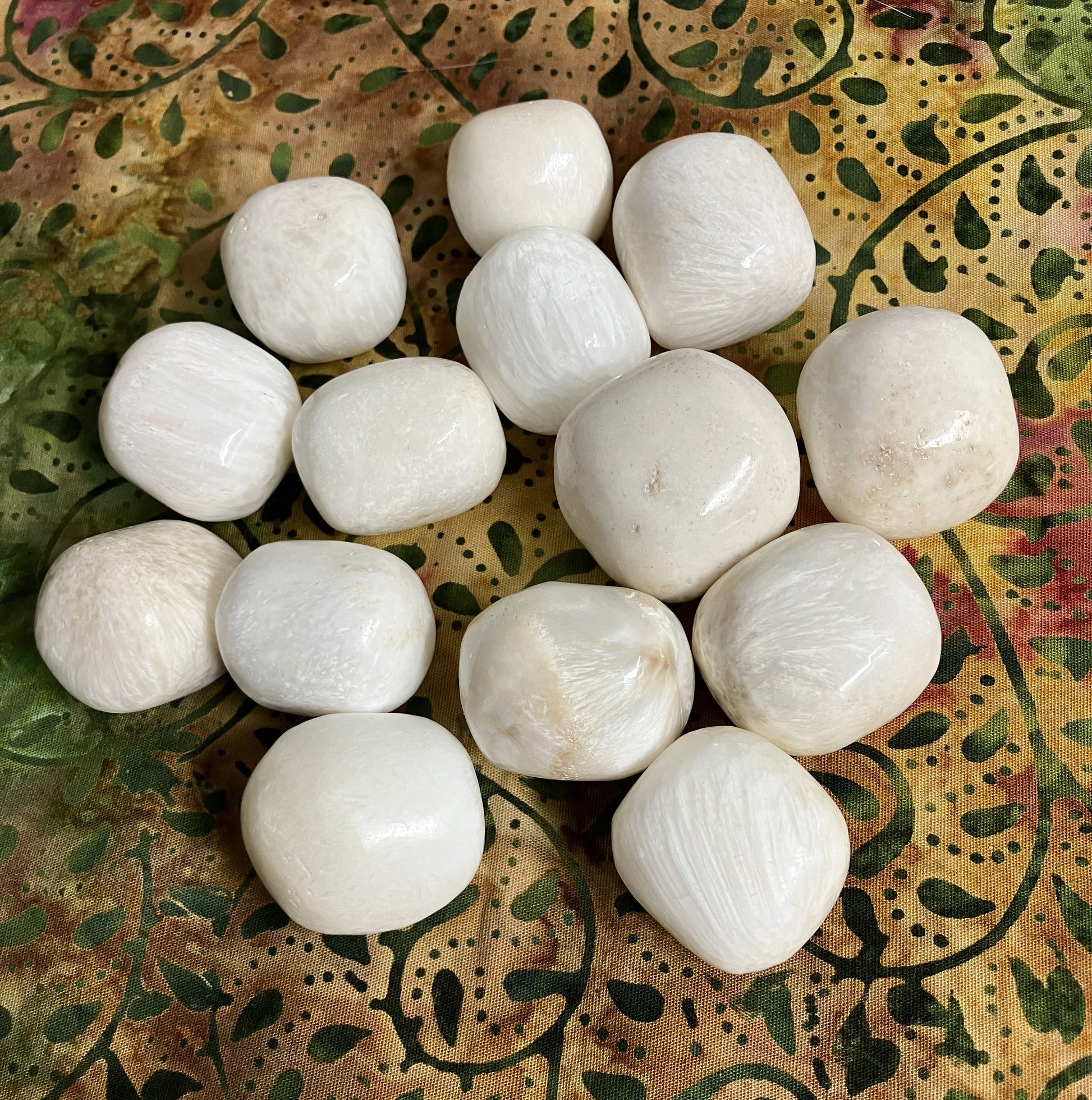 Front view of Scolecite Crystals on a patterned fabric background