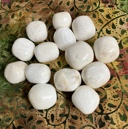 Front view of Scolecite Crystals on a patterned fabric background