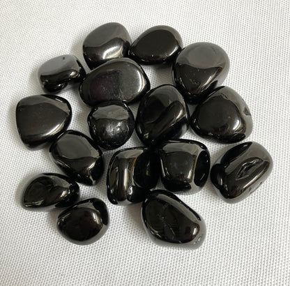 Showing an assortment of Jet Crystals on a white fabric background