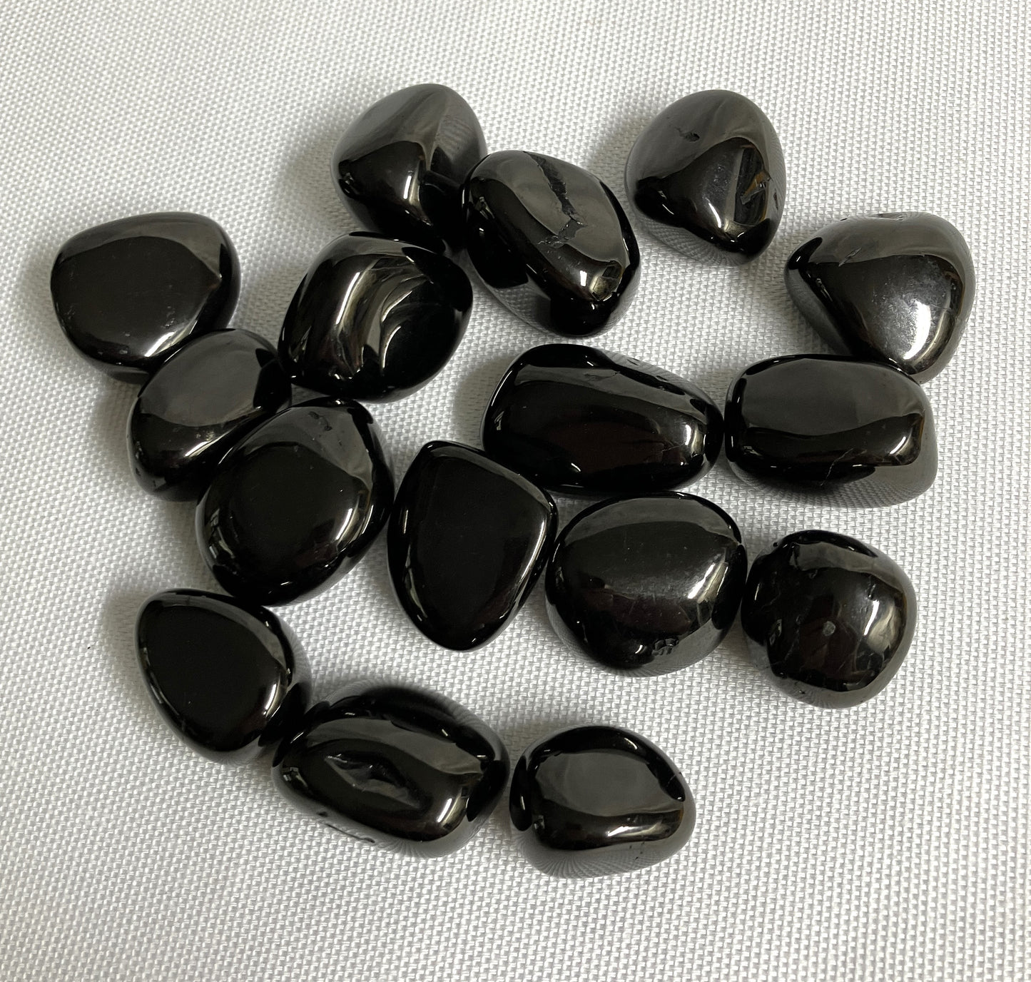 Front view of Jet Crystals on a white fabric background