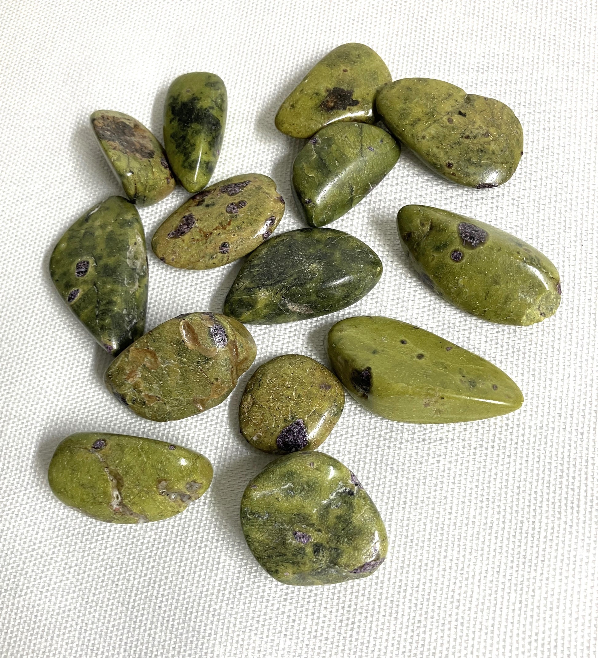 Front view of Stichtite with Serpentine Crystals AKA Alantistie on a white fabric background