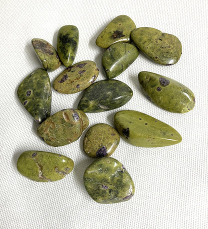 Front view of Stichtite with Serpentine Crystals AKA Alantistie on a white fabric background