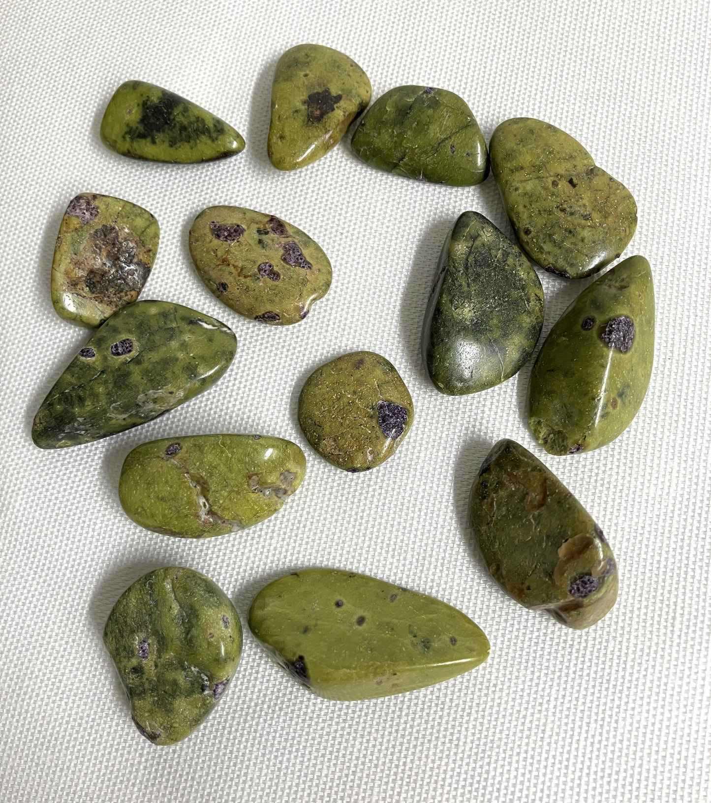 Group of Stichtite with Serpentine Crystals AKA Alantistie on a white fabric background