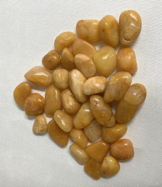 Closeup view of Apricot Quartz Crystals on a white fabric background