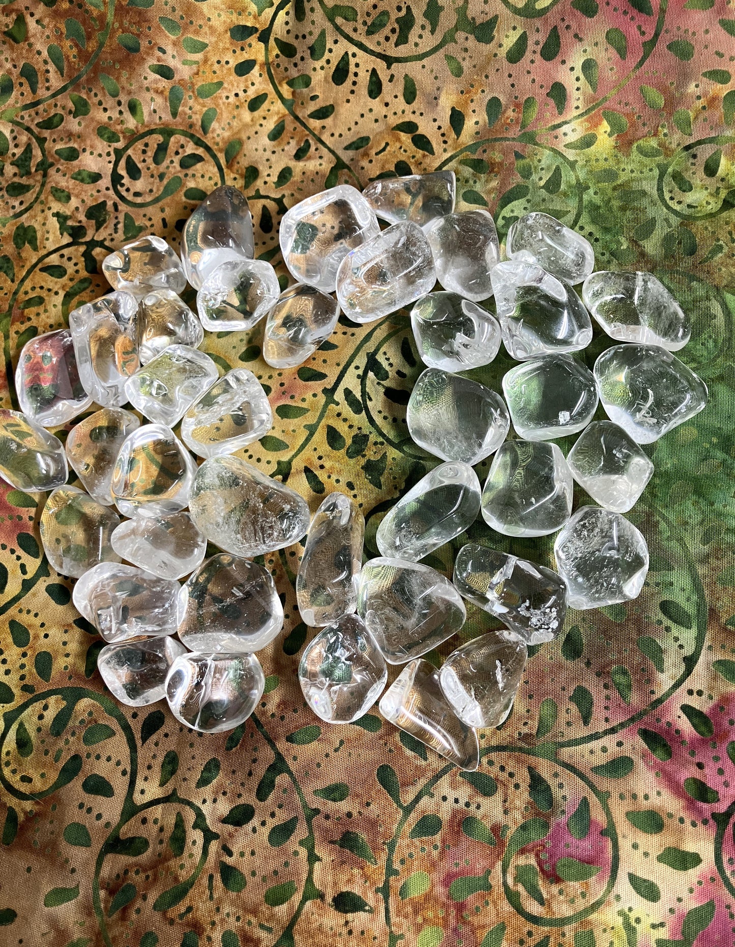 Clear Crystals Quartz shown on a colorful, patterned fabric background