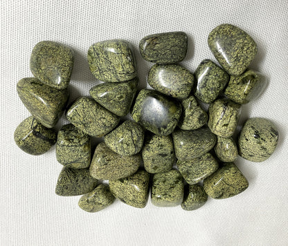 Collection of Asterite Serpentine Crystals on a white fabric background