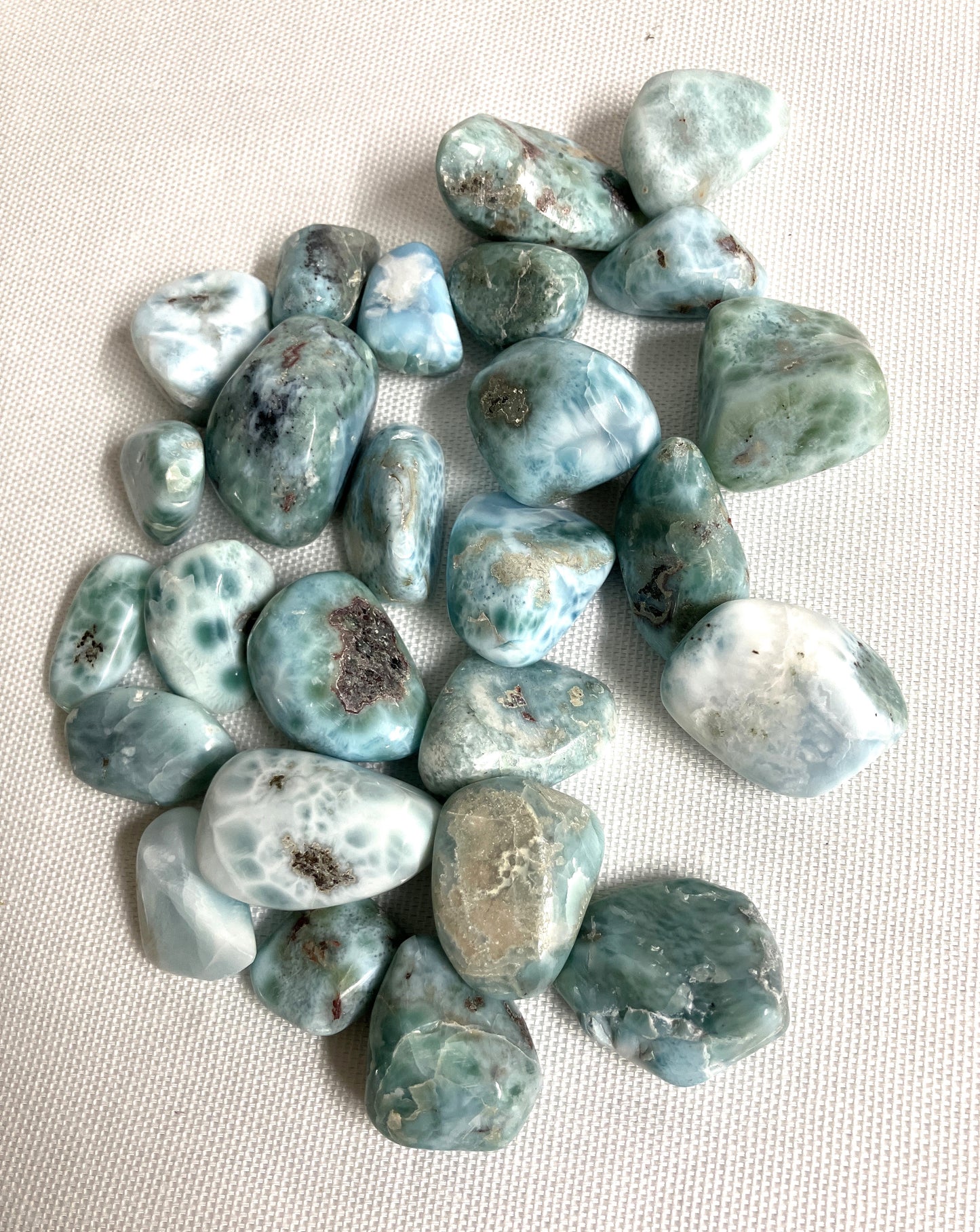 Collection of Larimar Crystals showing front side on a light beige background