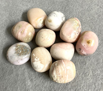 Closeup of Pink Opal Crystals on a gray surface