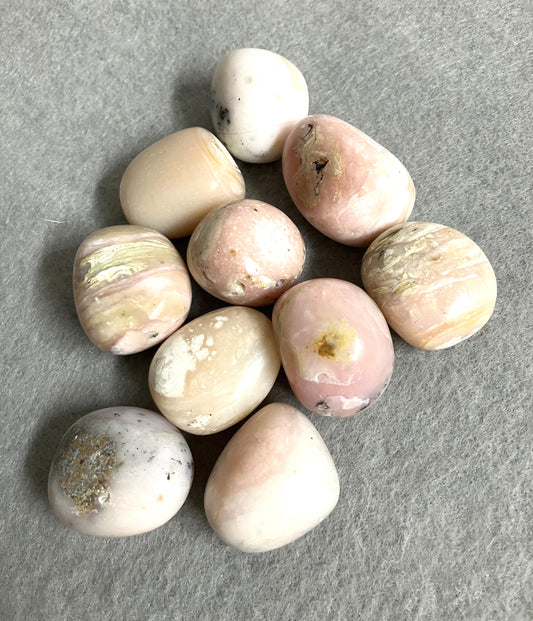 Collection of Pink Opal Crystals on a gray surface