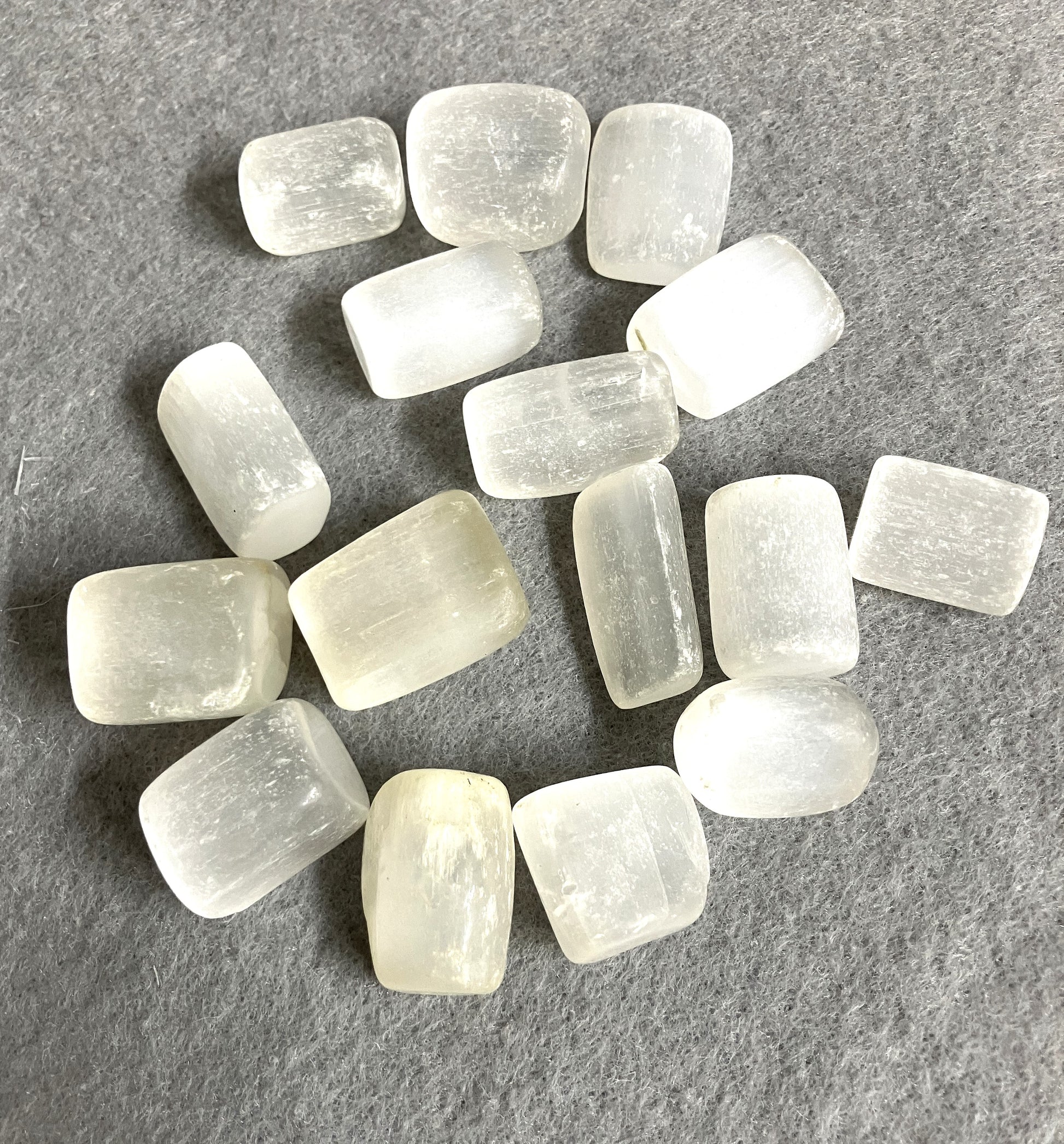 Selenite Crystals shown on a gray fabric to highlight the pattern