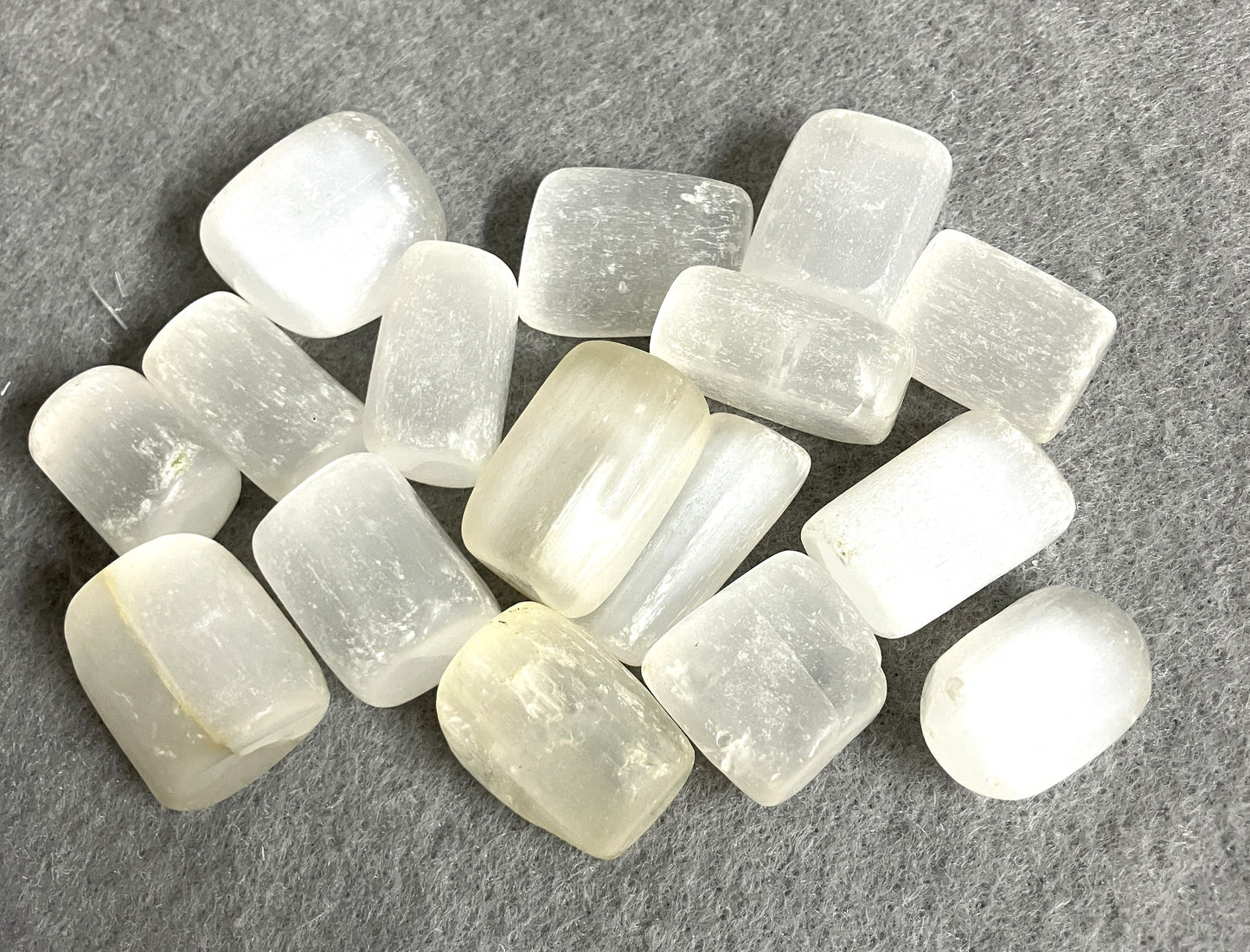 Group of Selenite Crystals showing a closeup on a gray surface