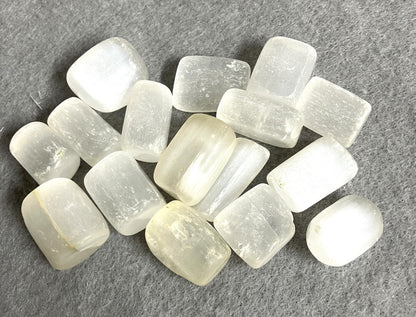 Group of Selenite Crystals showing a closeup on a gray surface