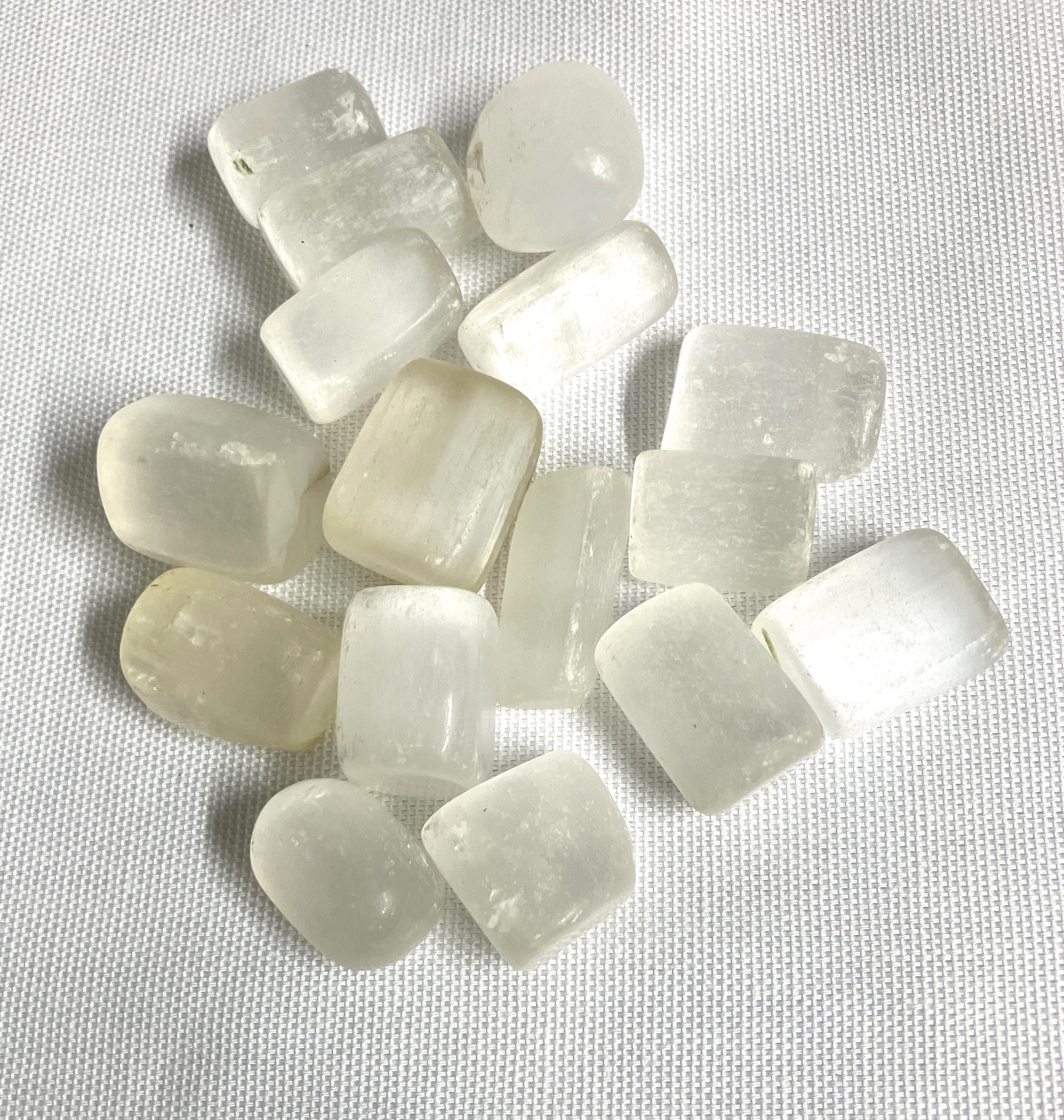 Assorted Selenite Crystals on a textured white background