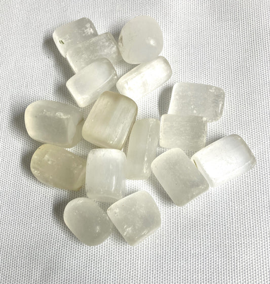 Assorted Selenite Crystals on a textured white background
