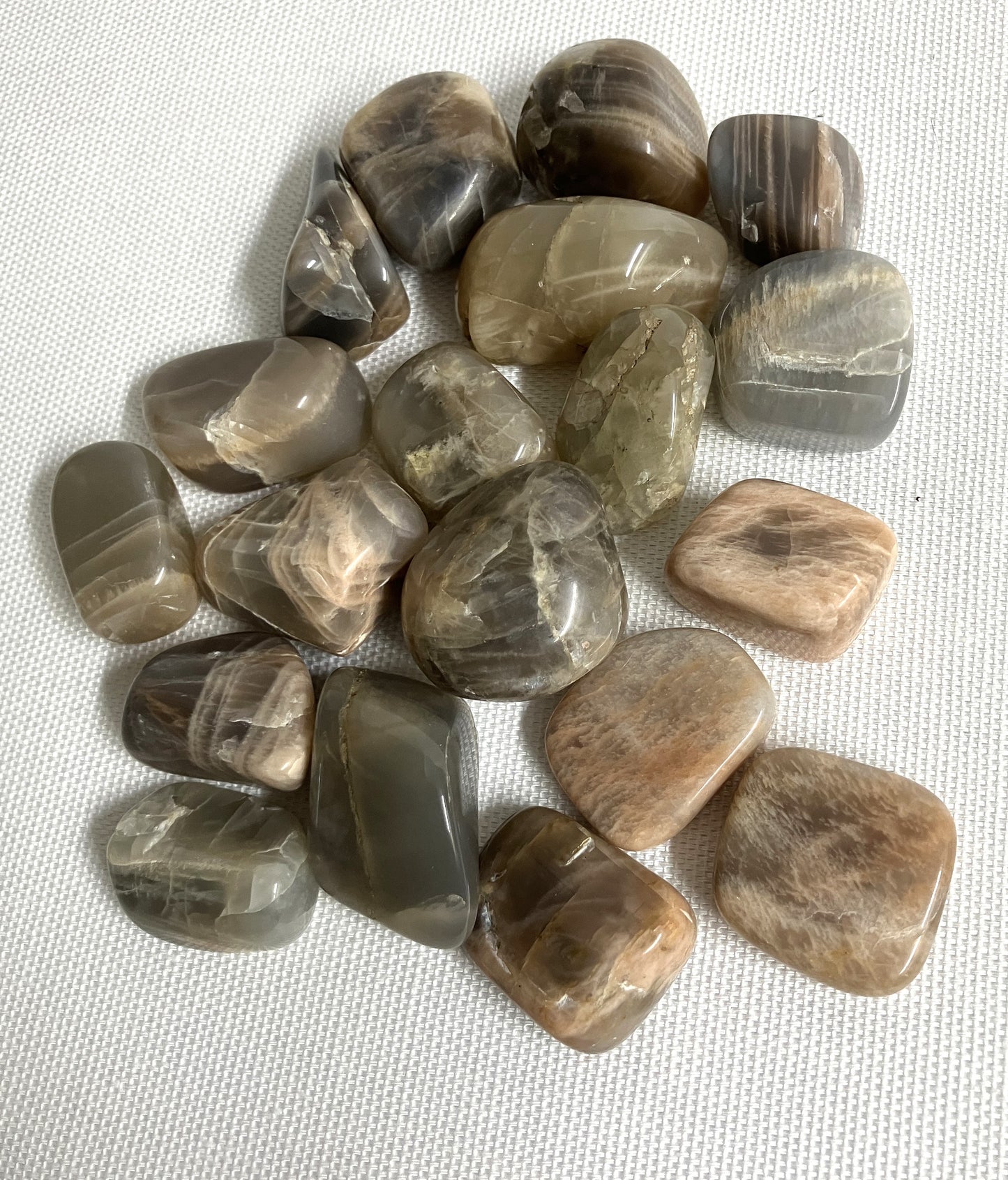 Closeup of Black Moonstone Crystals on a white fabric background