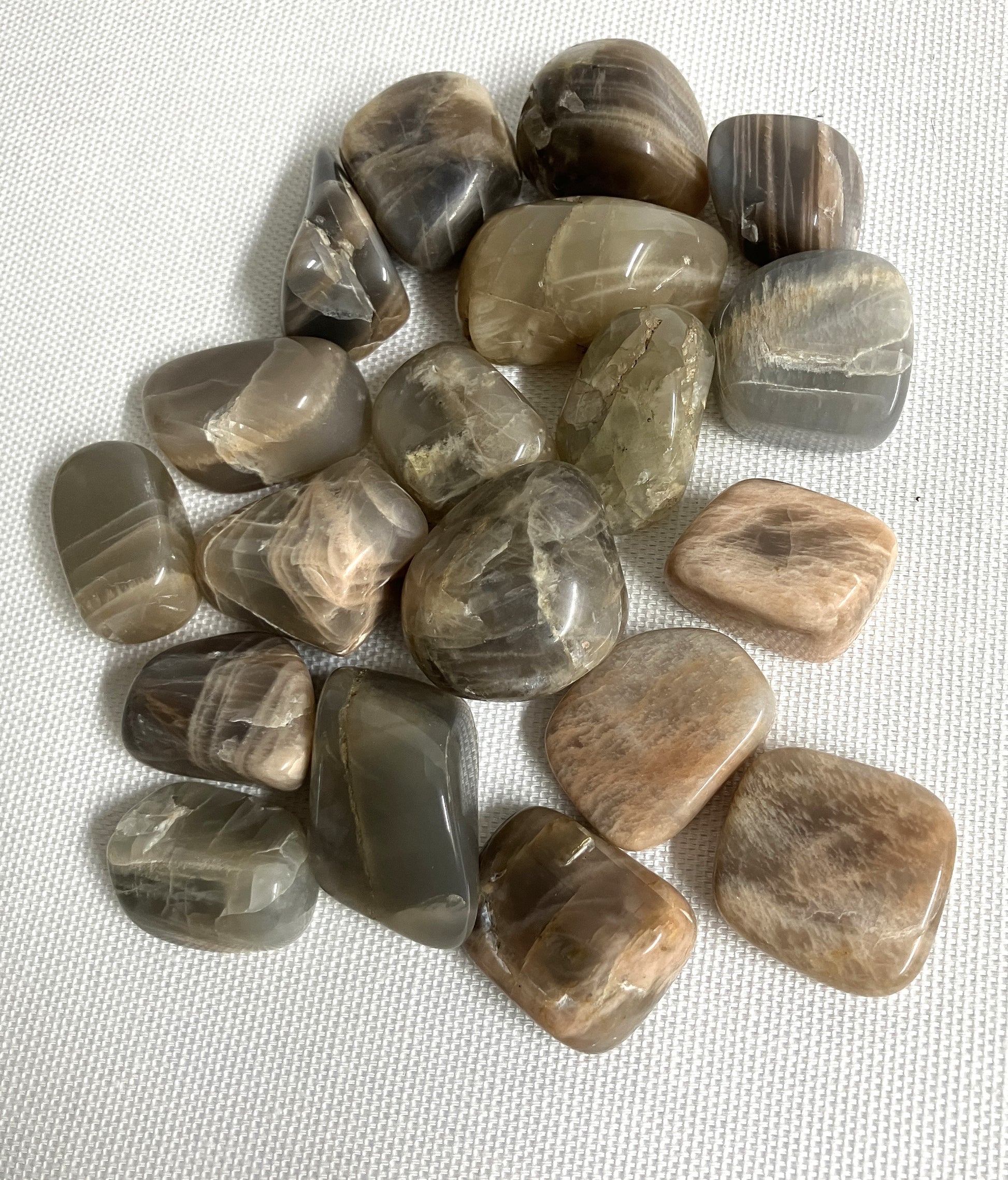 Closeup of Black Moonstone Crystals on a white fabric background