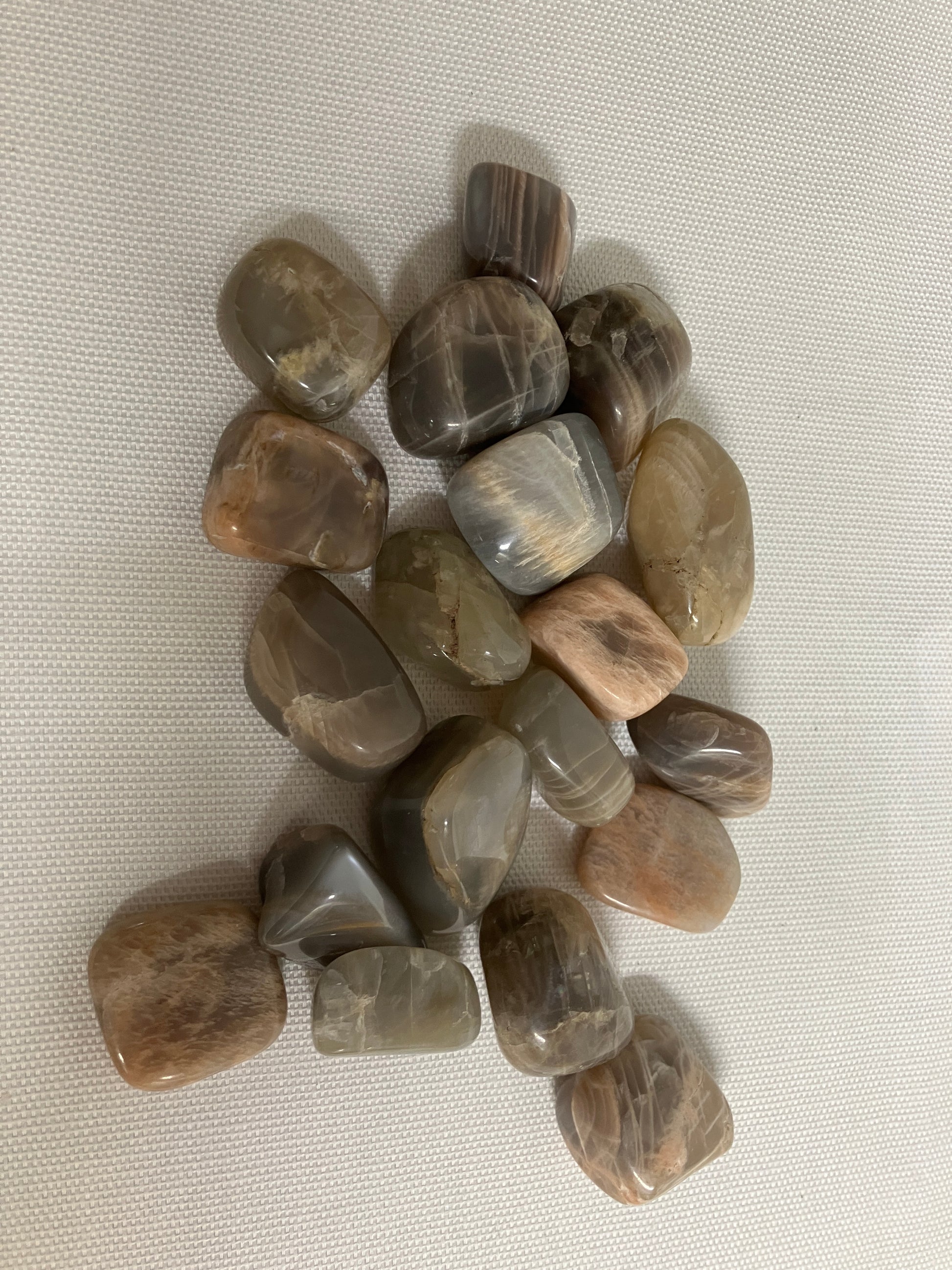Bottom view of Black Moonstone Crystals on a light fabric background