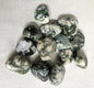 Front view of Tree Agate Crystals on a textured white surface