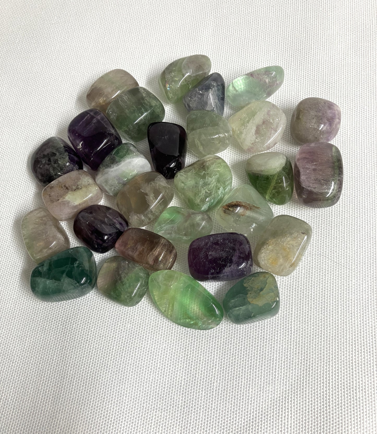 Tumbled Fluorite Crystals on a white fabric background