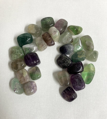 Assorted Fluorite Crystals showing the front view on a white fabric background