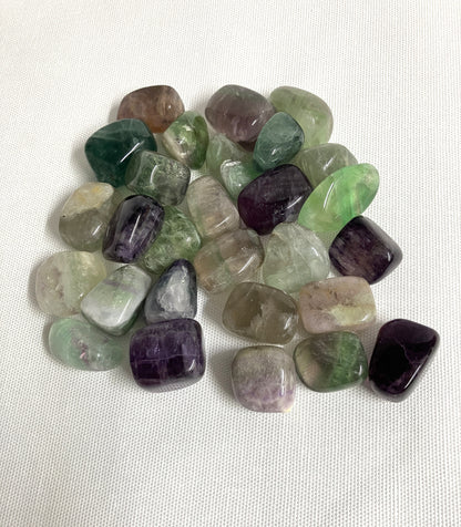 Assorted tumbled Fluorite Crystals on a white background