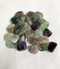 Assorted tumbled Fluorite Crystals on a white background