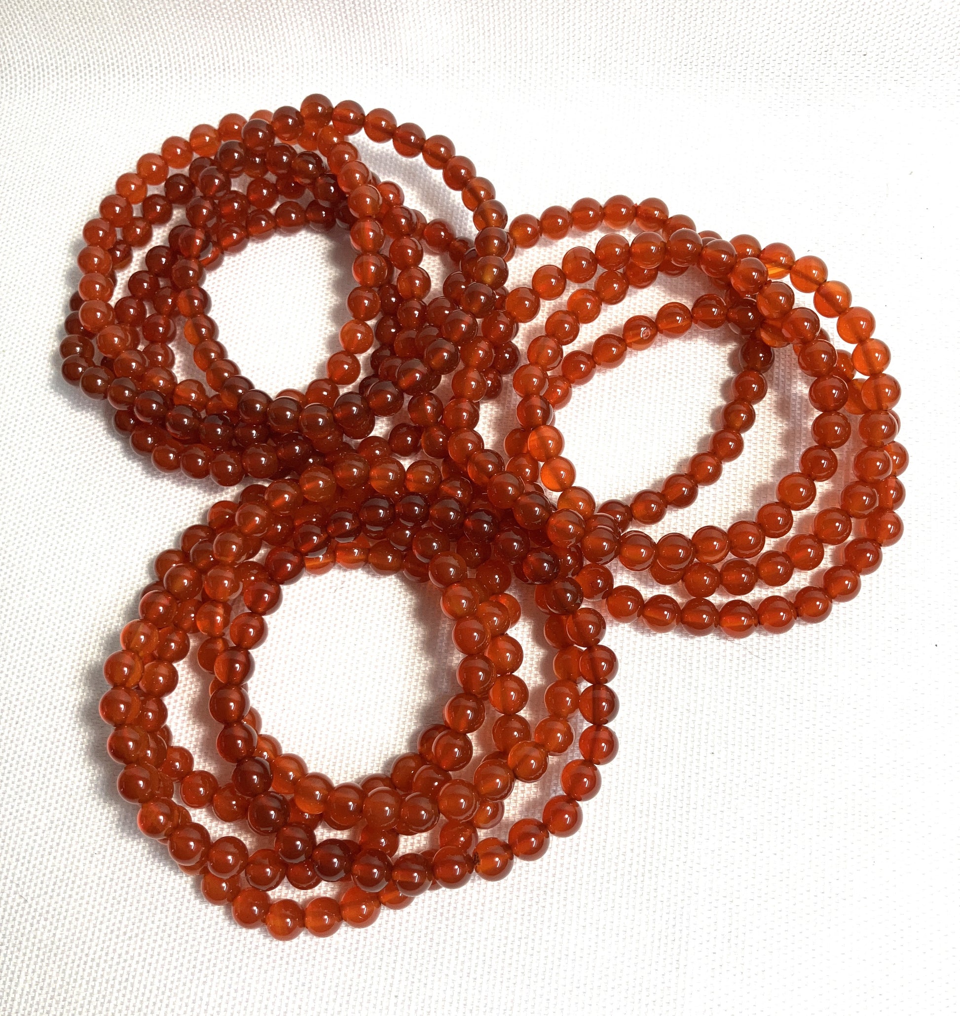 Group of Carnelian Beaded Stretch Bracelets on a white background