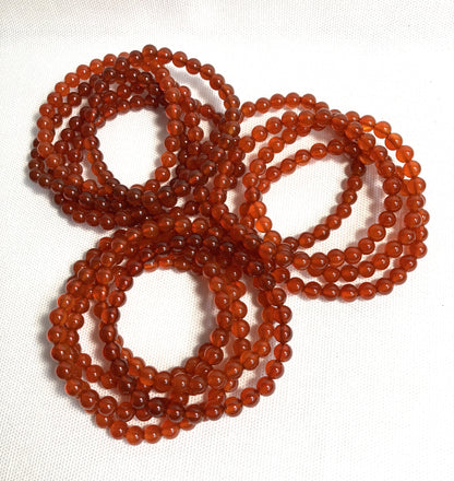Group of Carnelian Beaded Stretch Bracelets on a white background