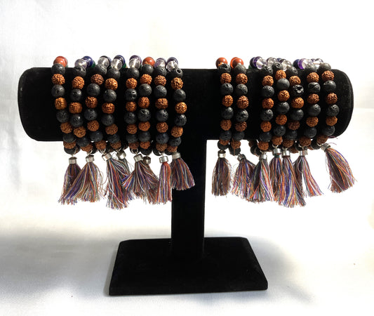 Chakra Stone Stretch Bracelet w/ Lava and Rudraksha Seeds on a black stand against a white background
