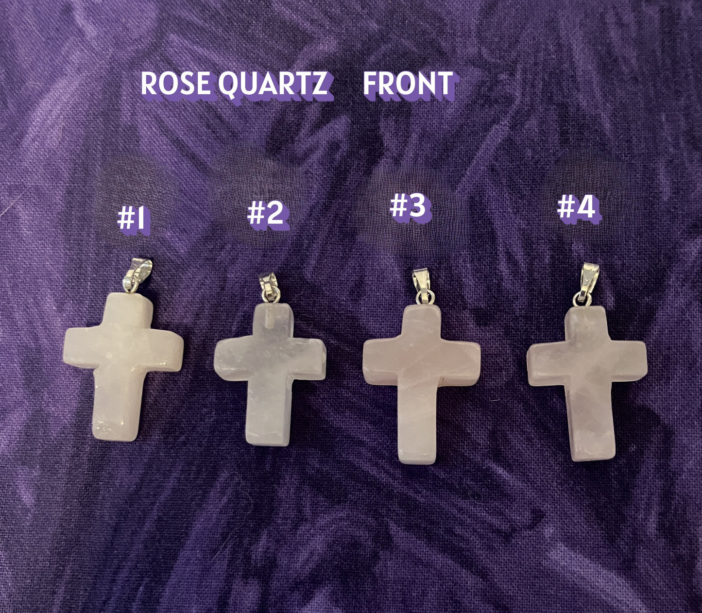 Front view of four rose quartz cross pendants labeled with numbers on a purple textured background