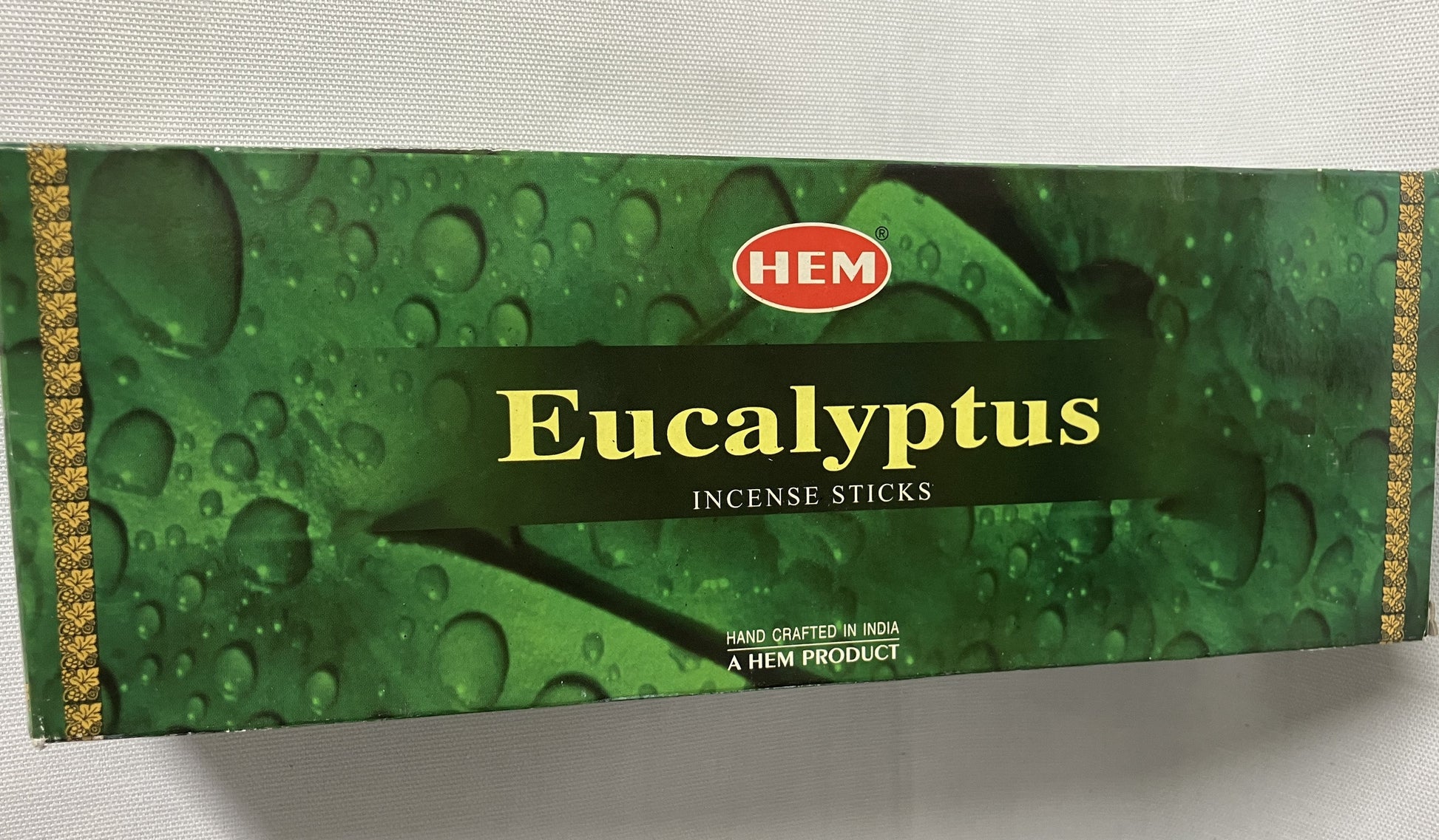 Eucalyptus incense master carton packaging with water droplets on a white background