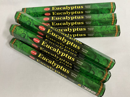 Multiple packages of HEM Eucalyptus incense sticks on a light background