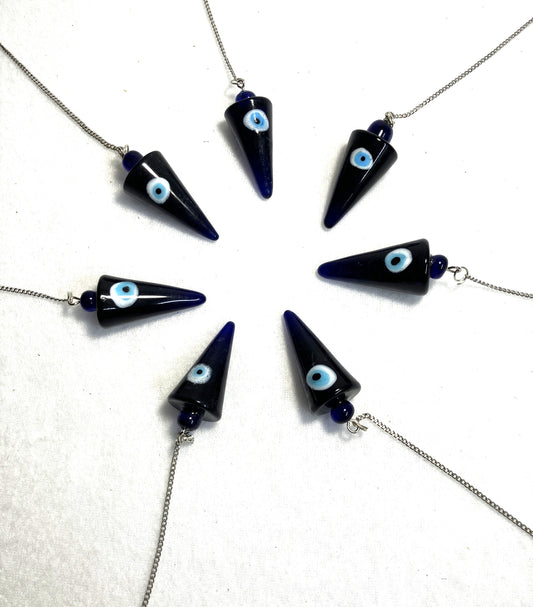Cobalt Blue Evil Eye Pendulums with light blue eyes on white iris against a white background arranged in a circle