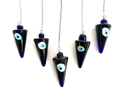 Five cobalt blue evil eye pendulums  against a white background.