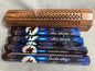 Four boxes of GR Magic Broom incense sticks if front of a decorative incense burner on a light gray background
