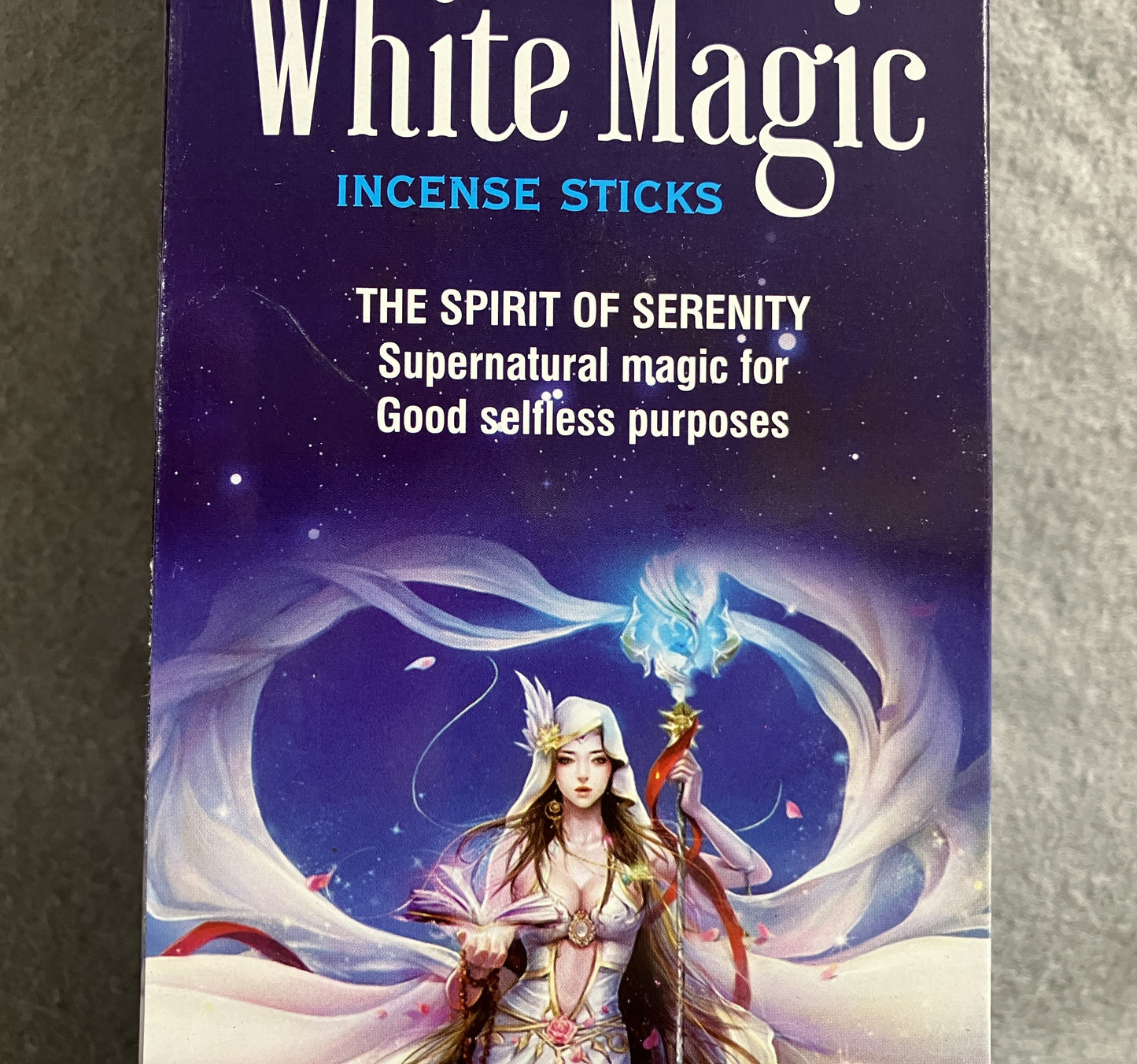 Packaging of White Magic incense sticks with a fantasy-themed design on a dark background.