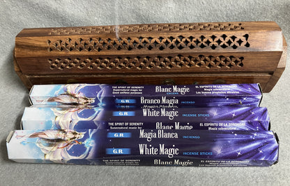 White Magic incense  boxes of 20 sticks with a wooden incense burner in the background.