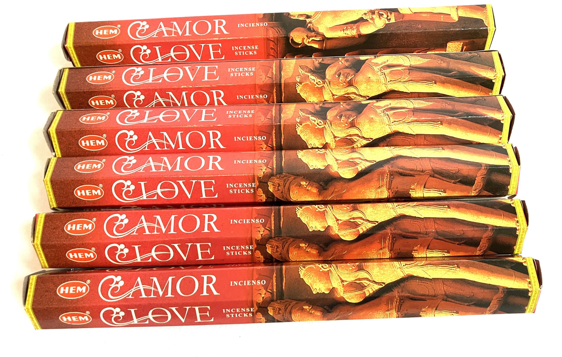 Multiple boxes of 'Amor' incense sticks with classical statue design on a white background