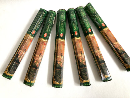 Multiple packages of 'Night Queen' incense sticks on a white background