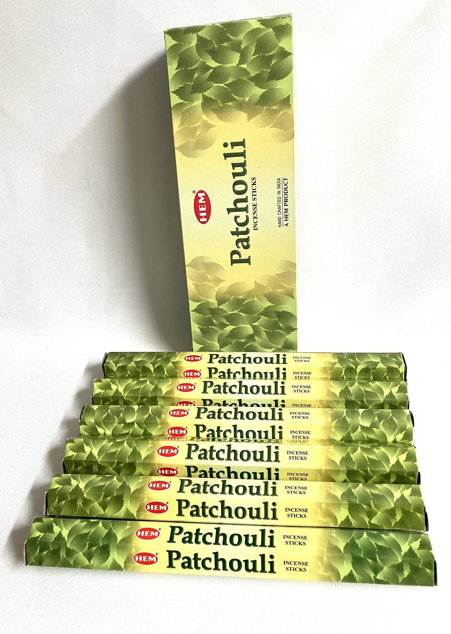 Stack of HEM Patchouli incense sticks on a white background