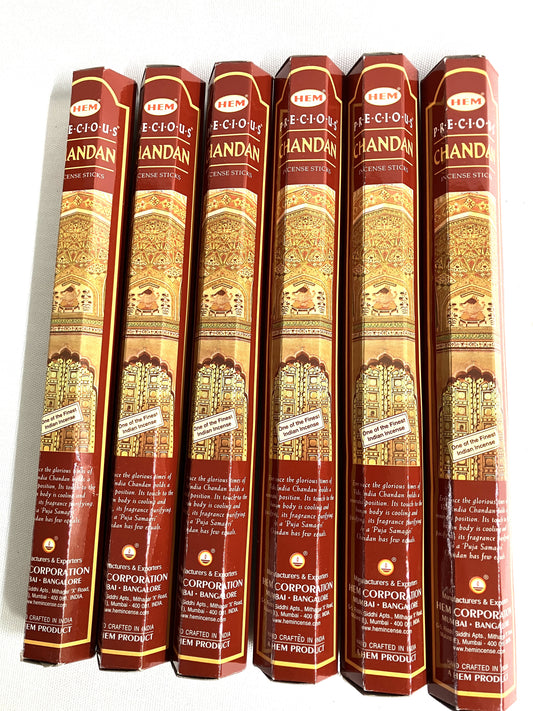 Six packages of Hem Precious Chandan incense sticks on a white background